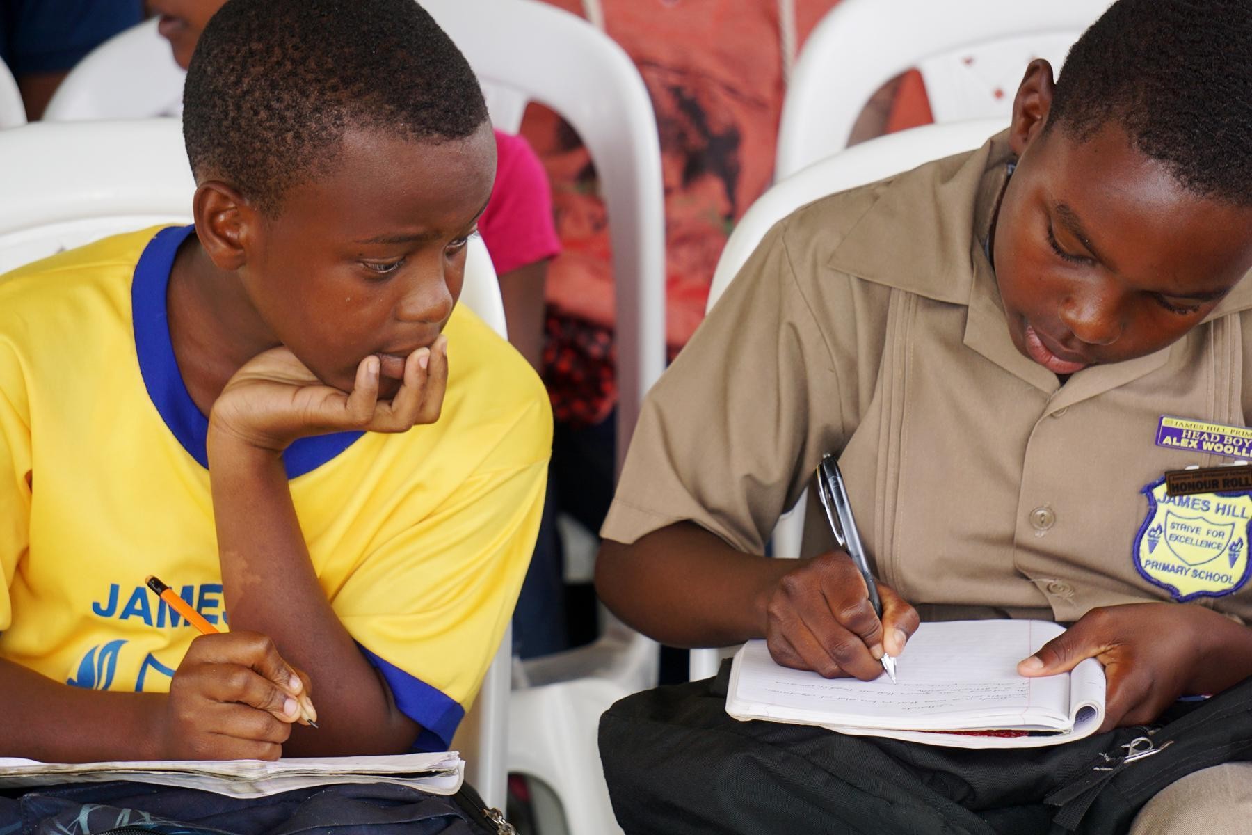 Students from the James Hill Primary School 
taking notes to keep informed during the day’s proceedings.